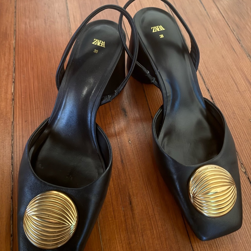 Zara: Black leather sling backs with gold brooch